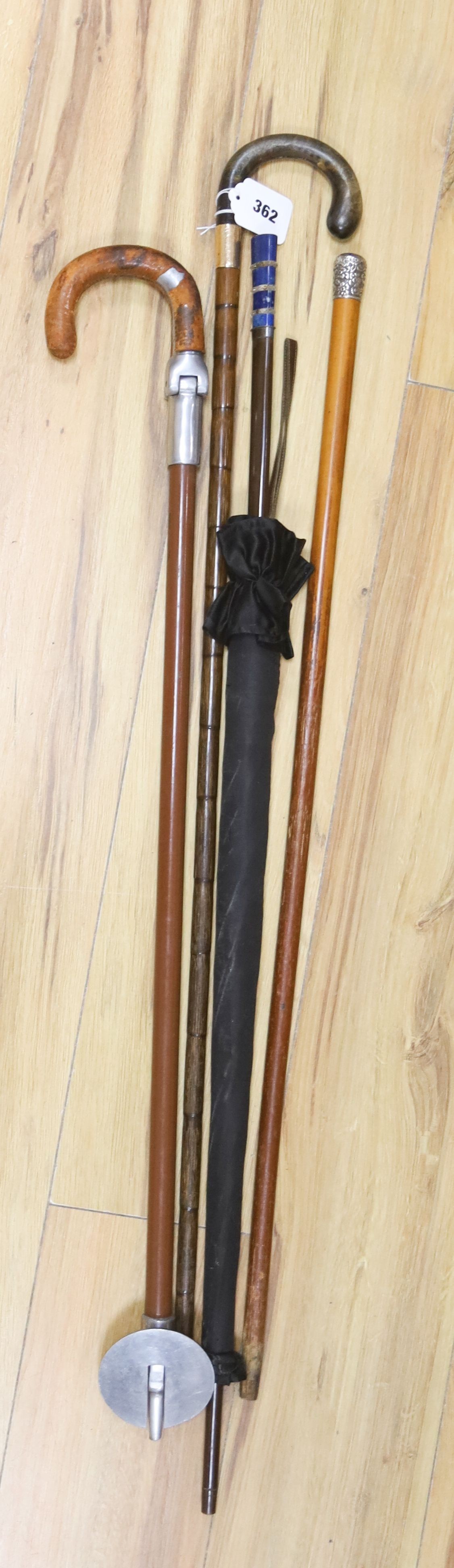A Victorian 9ct gold mounted walking stick, parasol, silver-mounted stick, etc